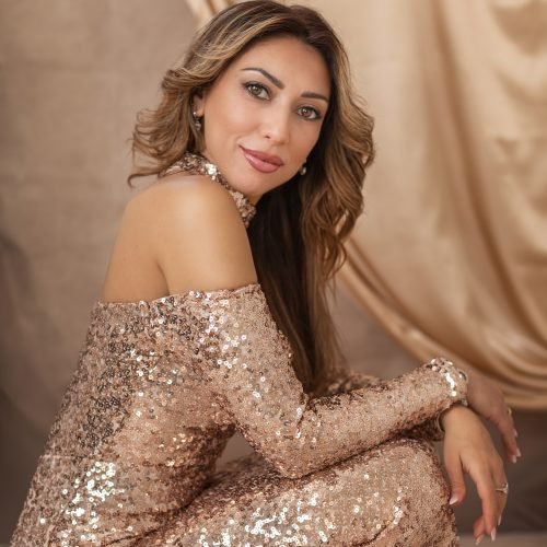 Studio glamorous portrait of Woman wearing a golden gown.