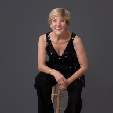 Studio portrait of a woman wearing black elegant jumpsuit